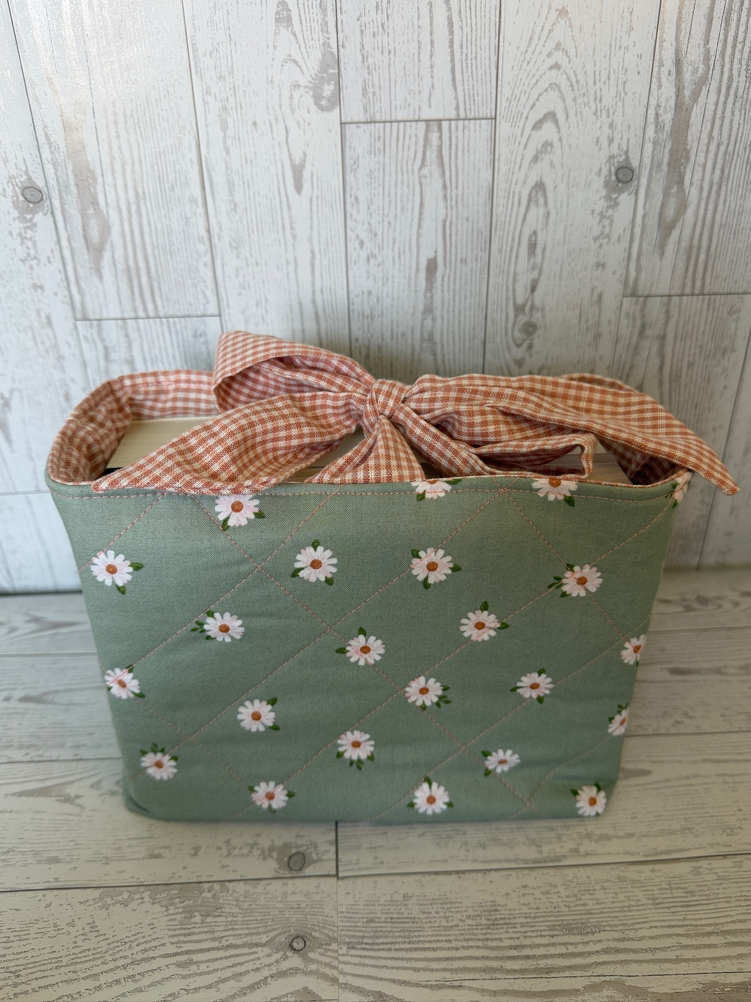 Handmade sage green daisy print padded book sleeve with rust gingham lining